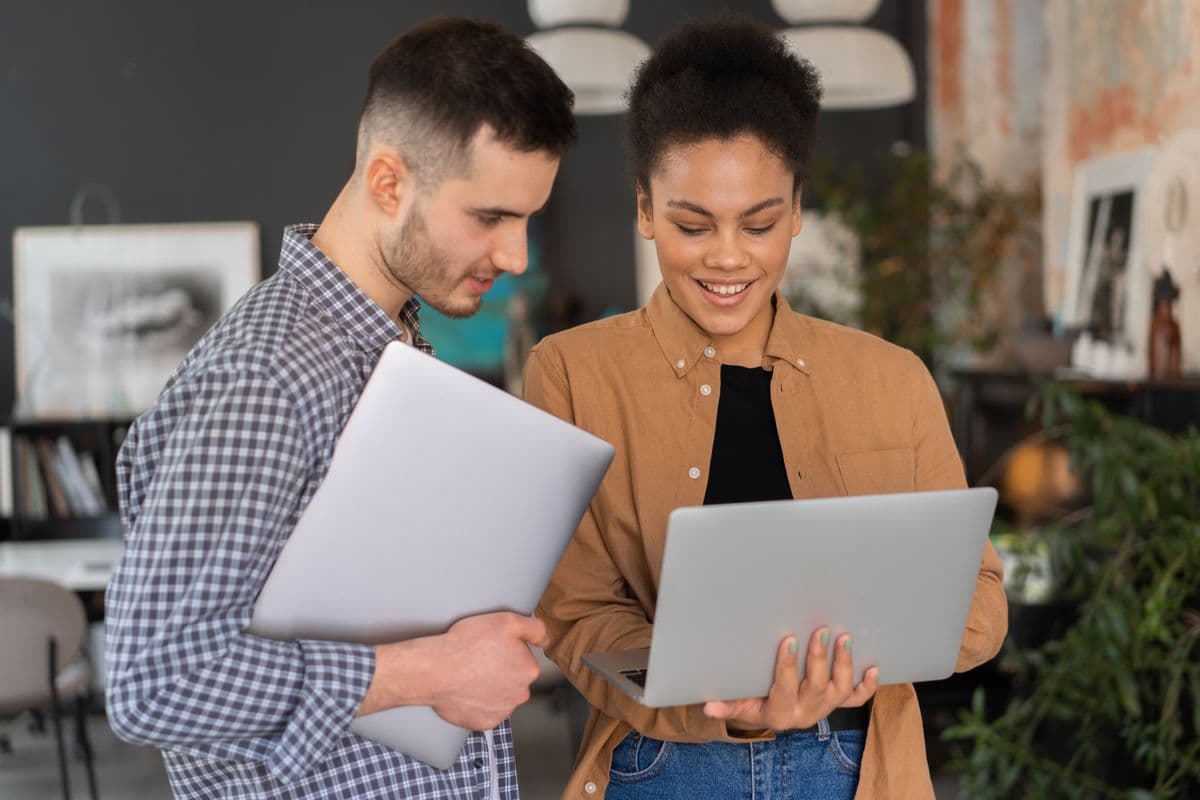 Freelancer conversando com cliente sobre alterações em um projeto diante de um notebook