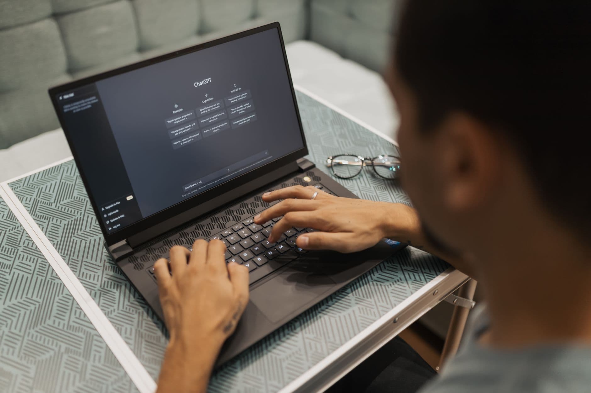 VPN para trabalho remoto: para que serve e quando usar A person using a laptop to interact with AI technology indoors during the day.